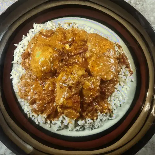 Overhead view low sodium Indian buttered chicken served over rice.