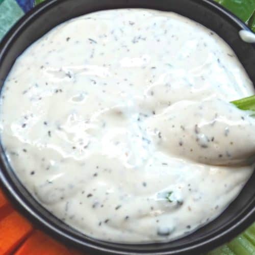 Celery dipped in ranch dressing