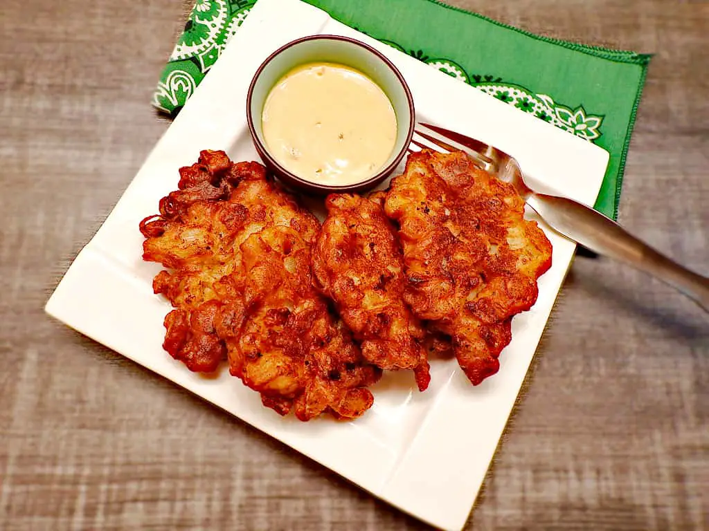 Low sodium onion fritters on white plate