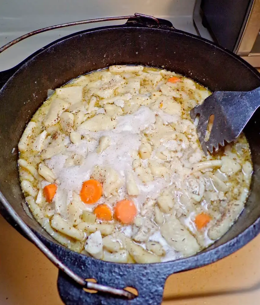 Chicken and dumplings cooking in cast iron pot