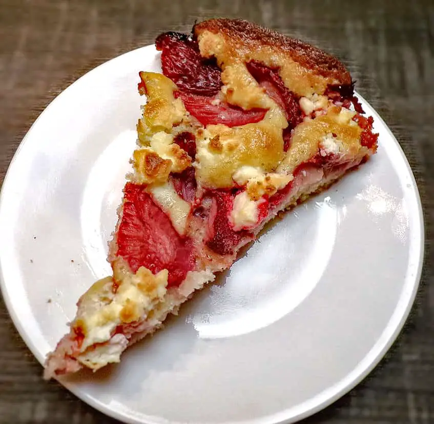 Still warm slice of strawberry cobbler on plate