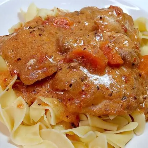 Chicken paprika on egg noodles