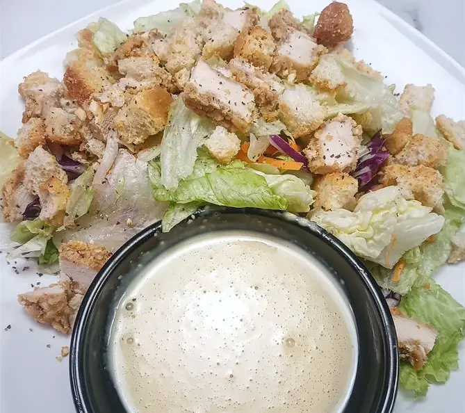 Lettuce, croutons, chicken and Caesar dressing