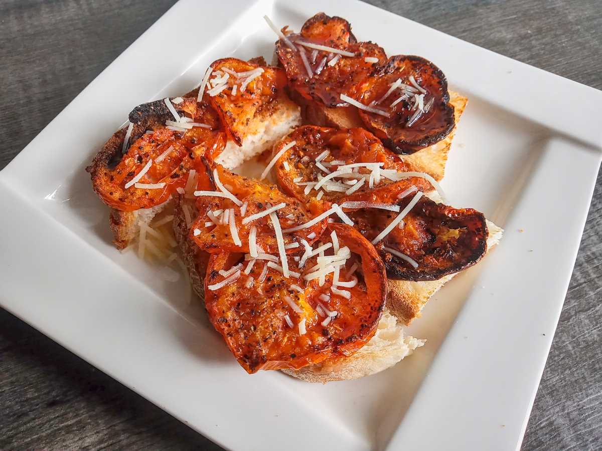 Low-sodium-roasted-tomatoes Low sodium roasted tomatoes as an appetizer on white serving platter.