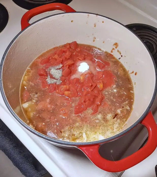 Adding tomatoes and broth