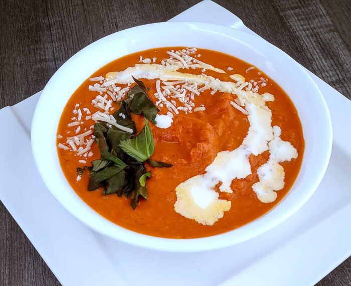 Low Sodium Tomato Soup in white bowl and platter