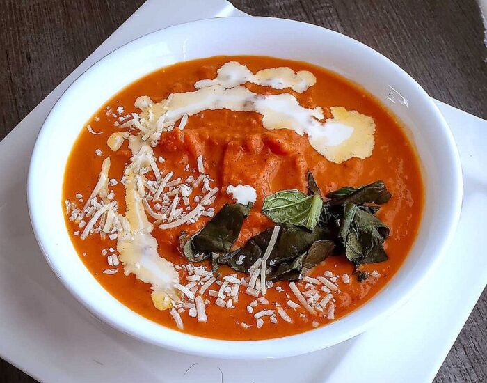 Low sodium tomato soup with cream drizzle and basil