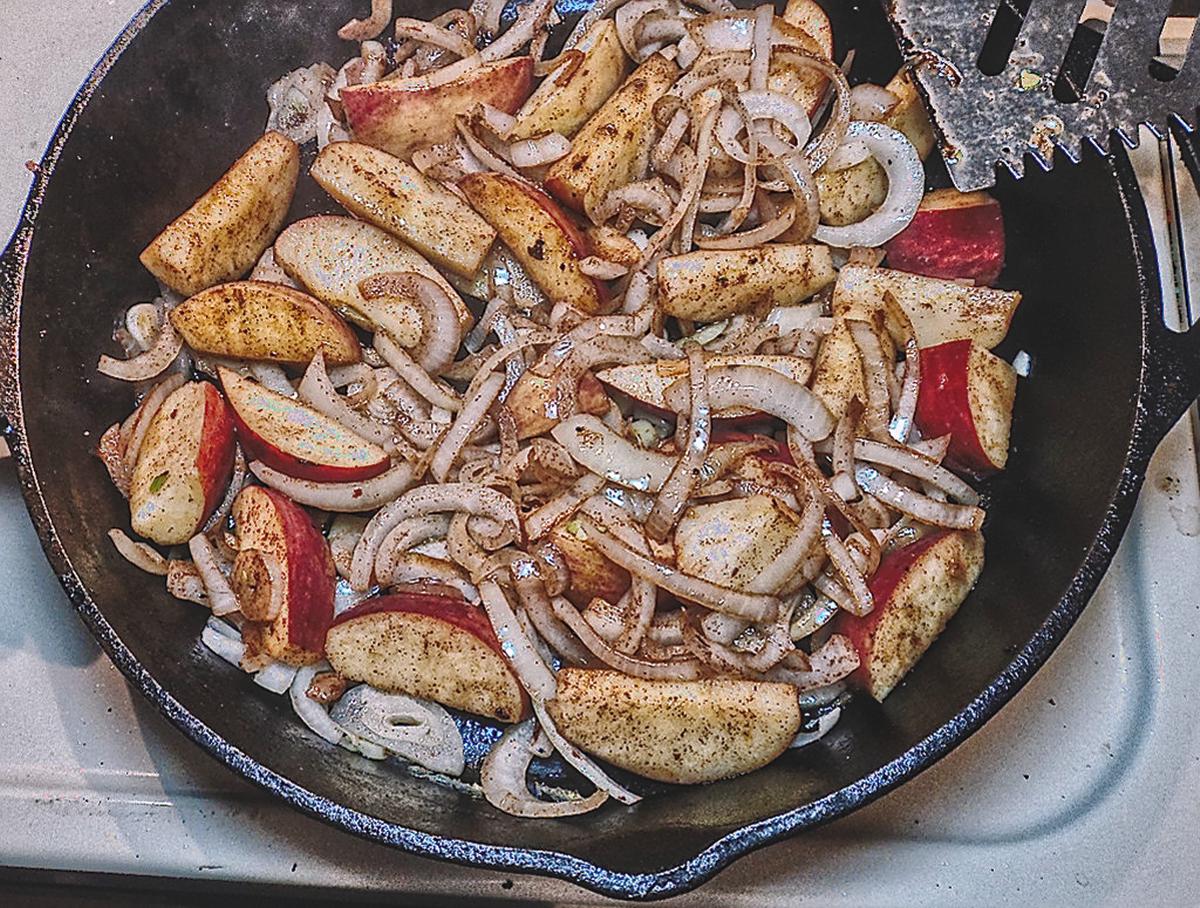 Apples and onions sauteing in skillet