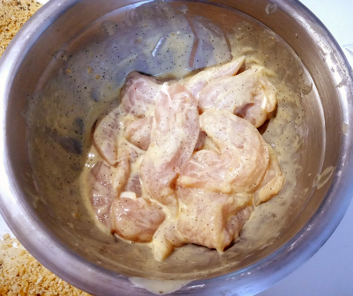 Chicken in batter ready to breadcumb