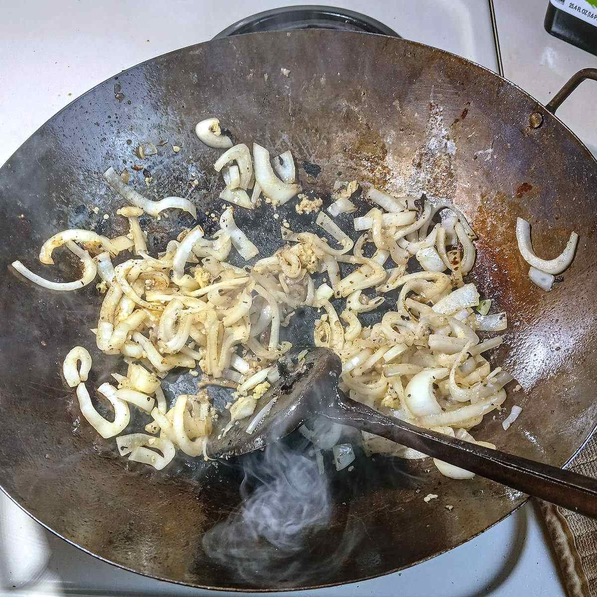 Low sodium chicken stir fry aromatics in wok.