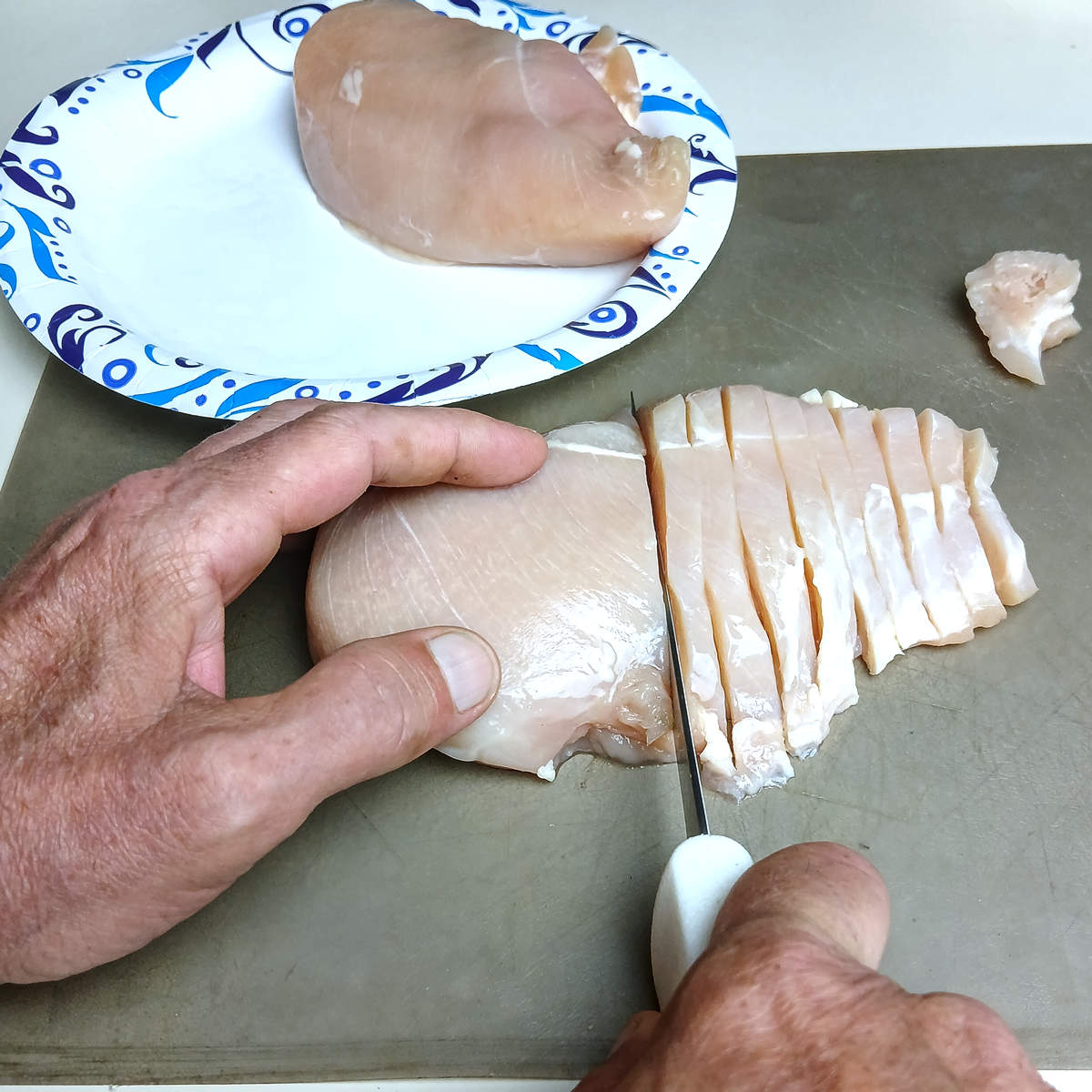 Low sodium chicken stir fry slicing chicken.