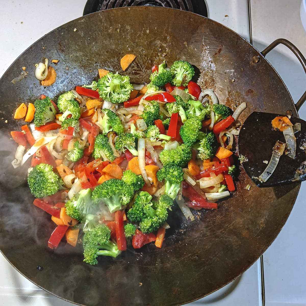 Low sodium chicken stir fry veggies in wok.