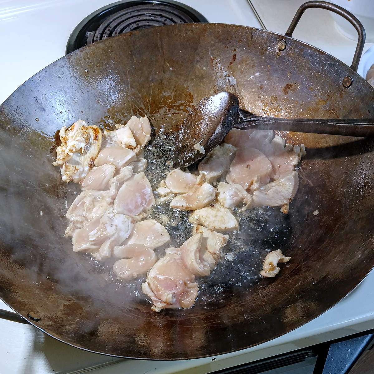 Low sodium chicken stir frying in wok