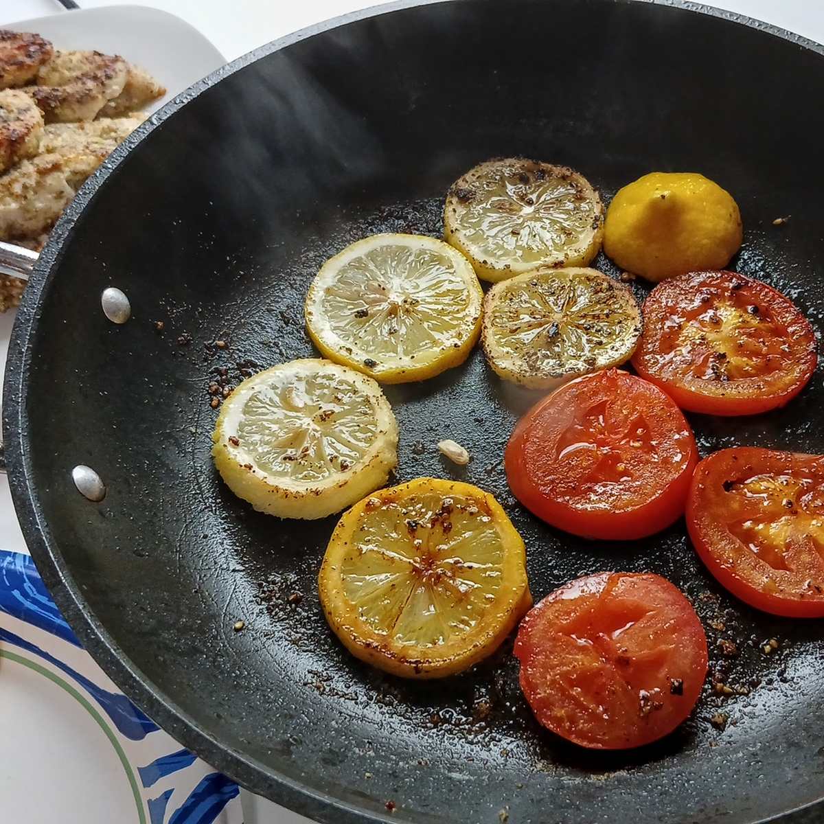 Low Sodium Lemon Pepper chicken roasting lemons and tomatoes