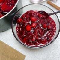 Low sodium sugar cranberries in a glass bowl with pot featured image