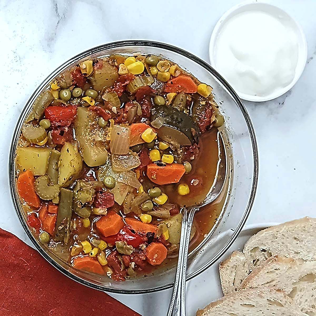 low sodium vegetable soup top view with yogurt and bread