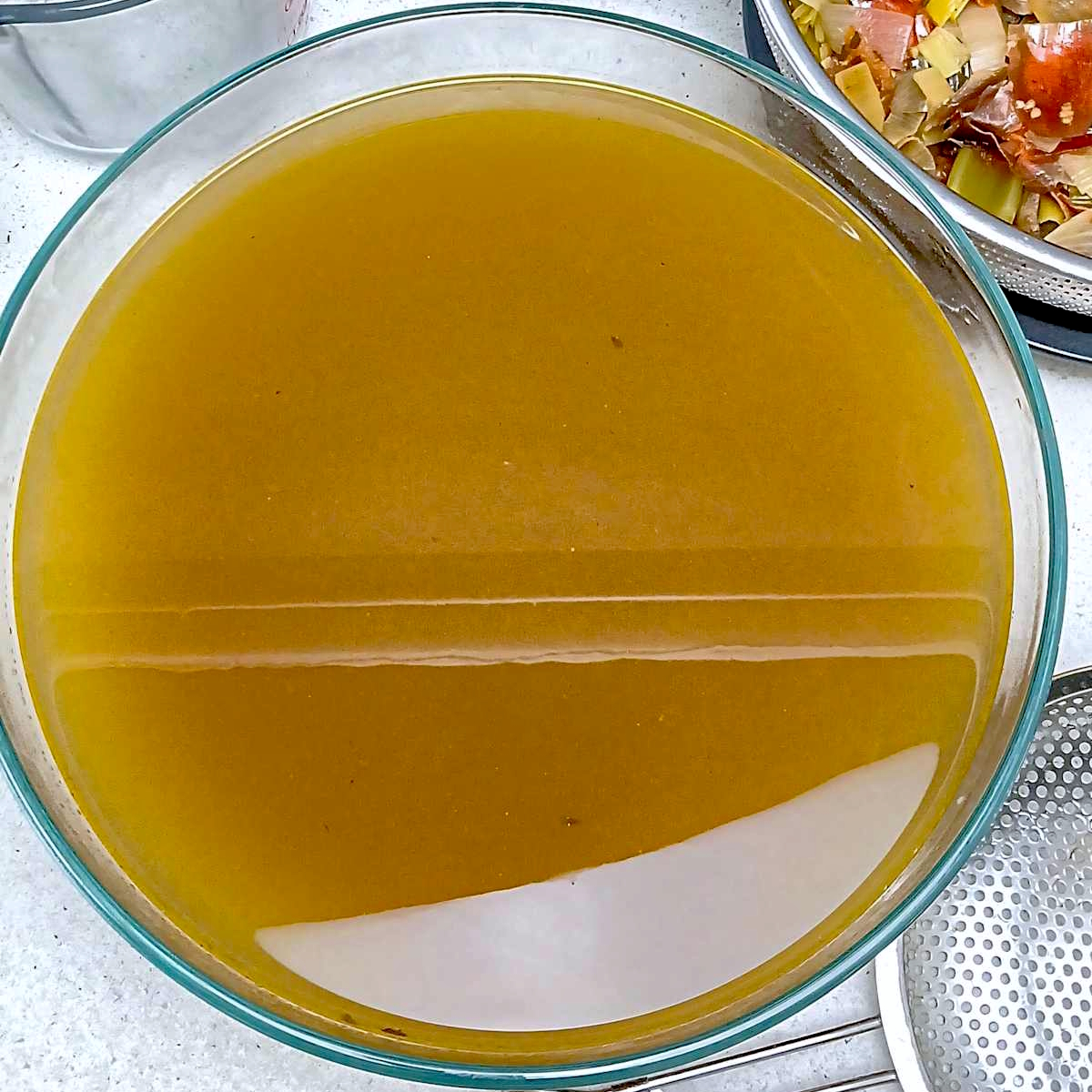 Featured image broth in large glass bowl low sodium vegetable broth stock