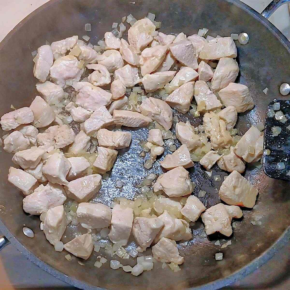 Cooking chicken and onions until brown - process shot 1