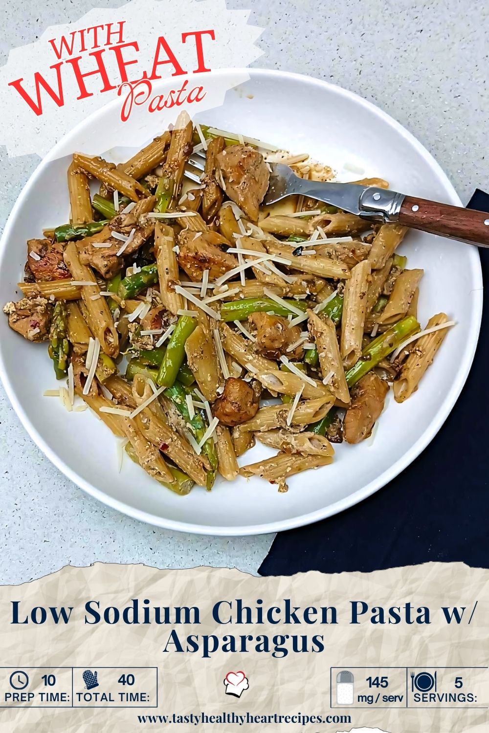 Low sodium pasta chicken with asparagus on a white plate with fork featuring wheat pasta. Pin Me