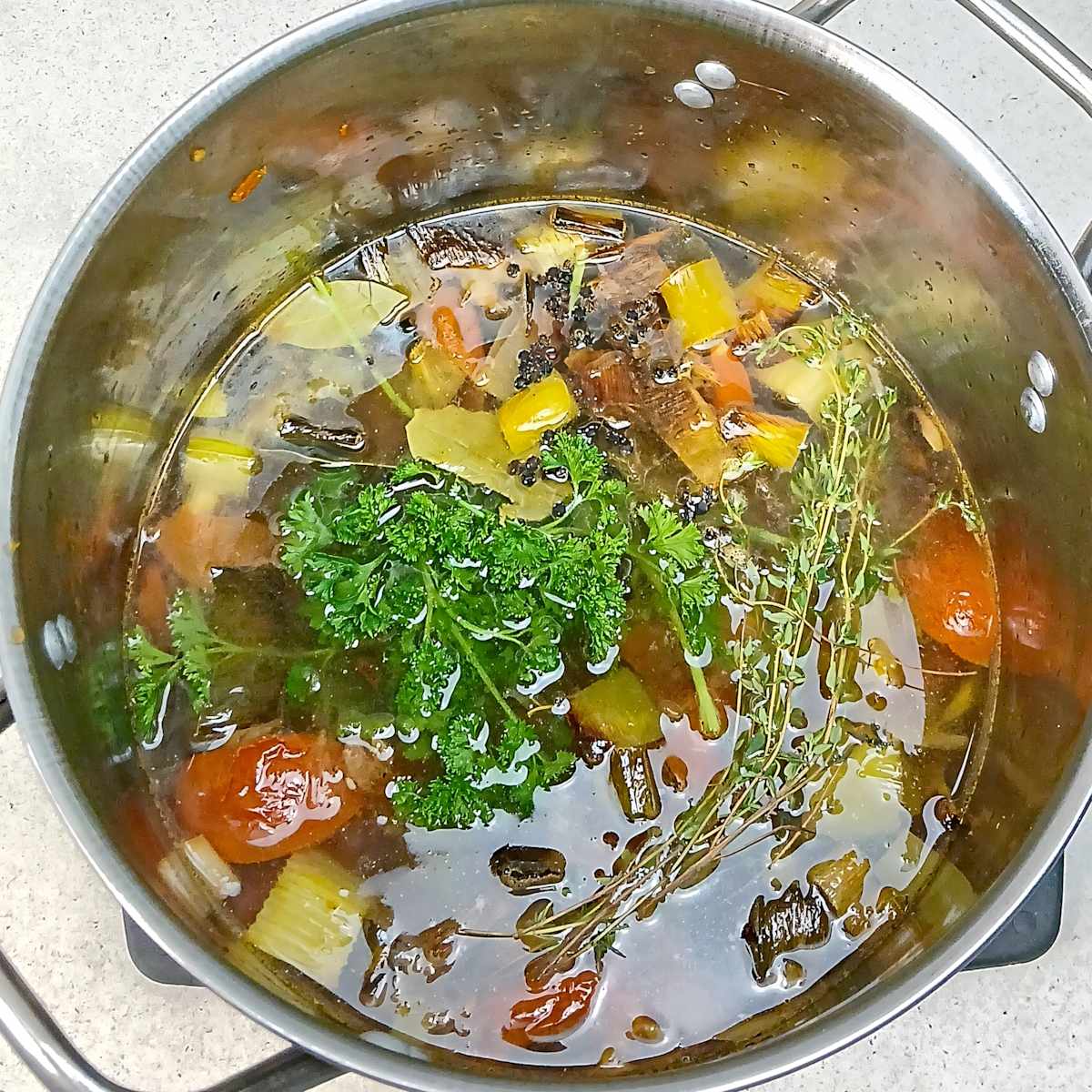 Vegetable in stock pot to simmer low sodium vegetable broth stock.