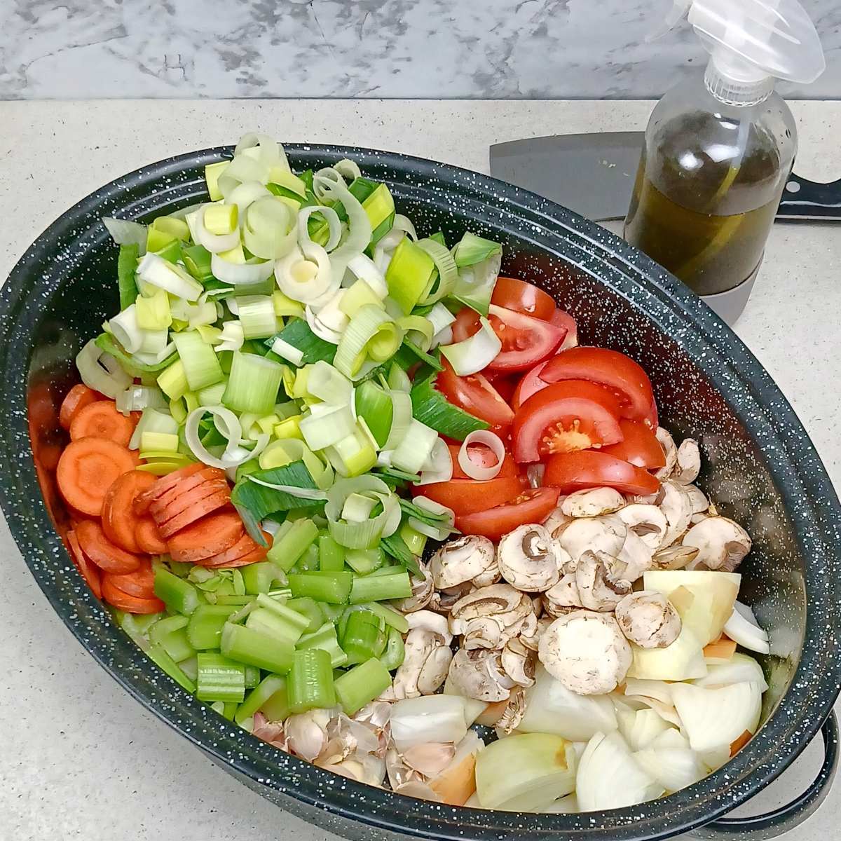 Vegetables chopped in roasting pan low sodium vegetable broth stock.