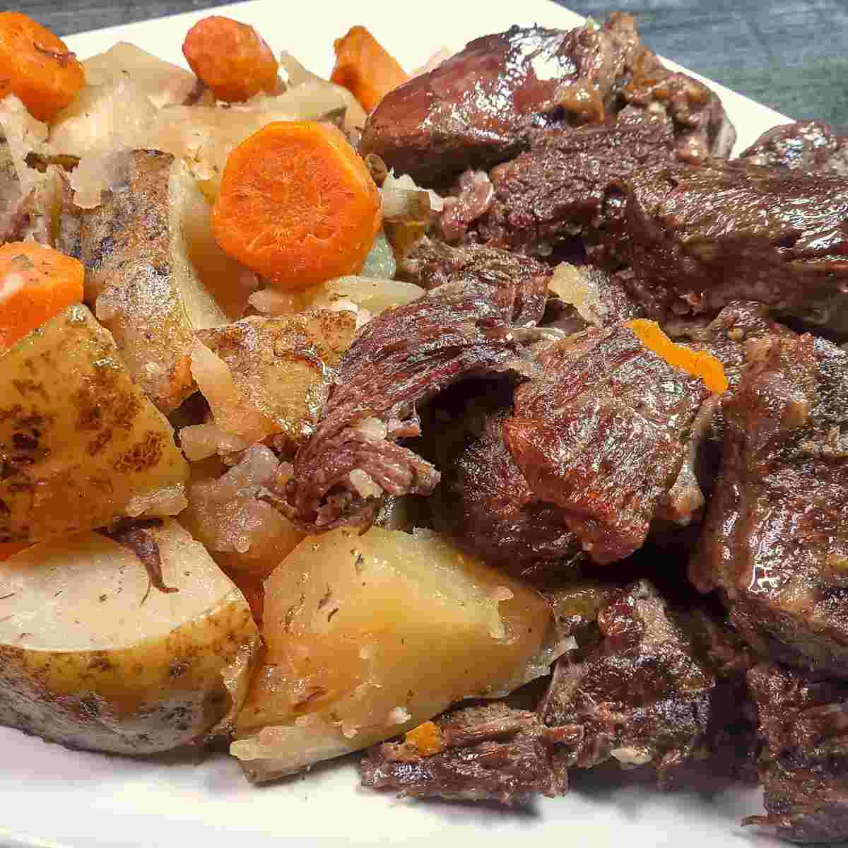 Close up of super tender roast beef, potatoes and carrots