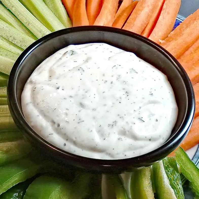 Low sodium ranch dressing on a platter with cut vegetables.