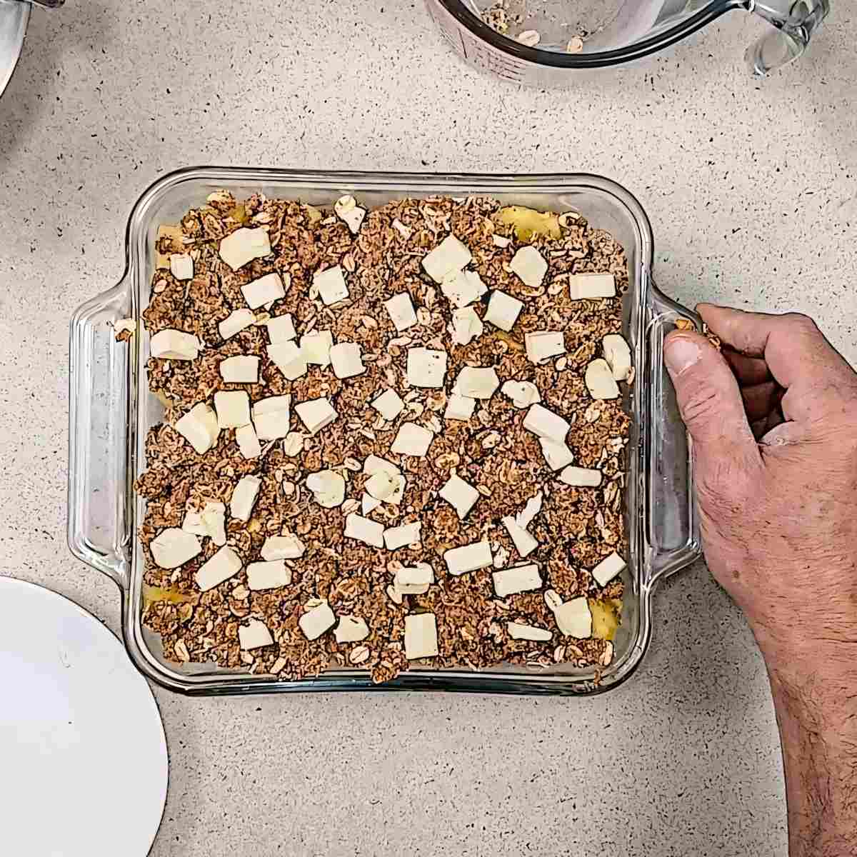 Low sodium pineapple crisp, place cubed butter over the mixture and place in oven process shot 8