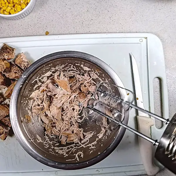 Shredding chicken with hand mixer.