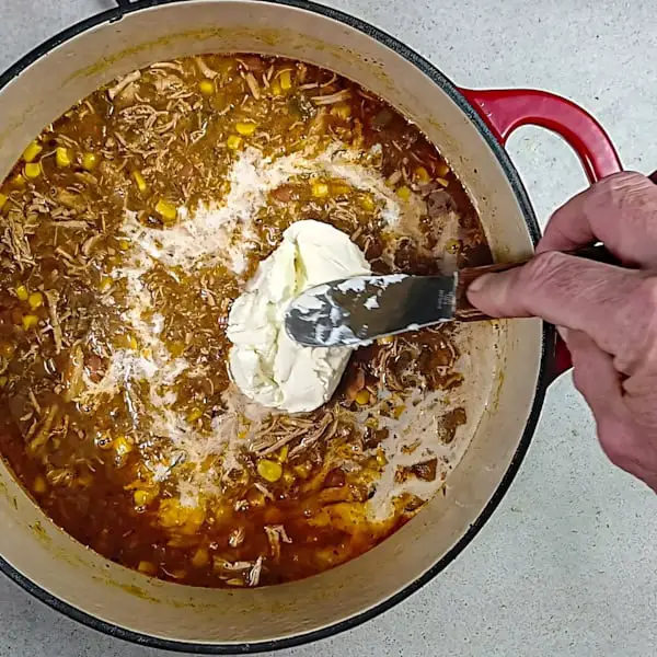 Adding cream and mascarpone cheese.