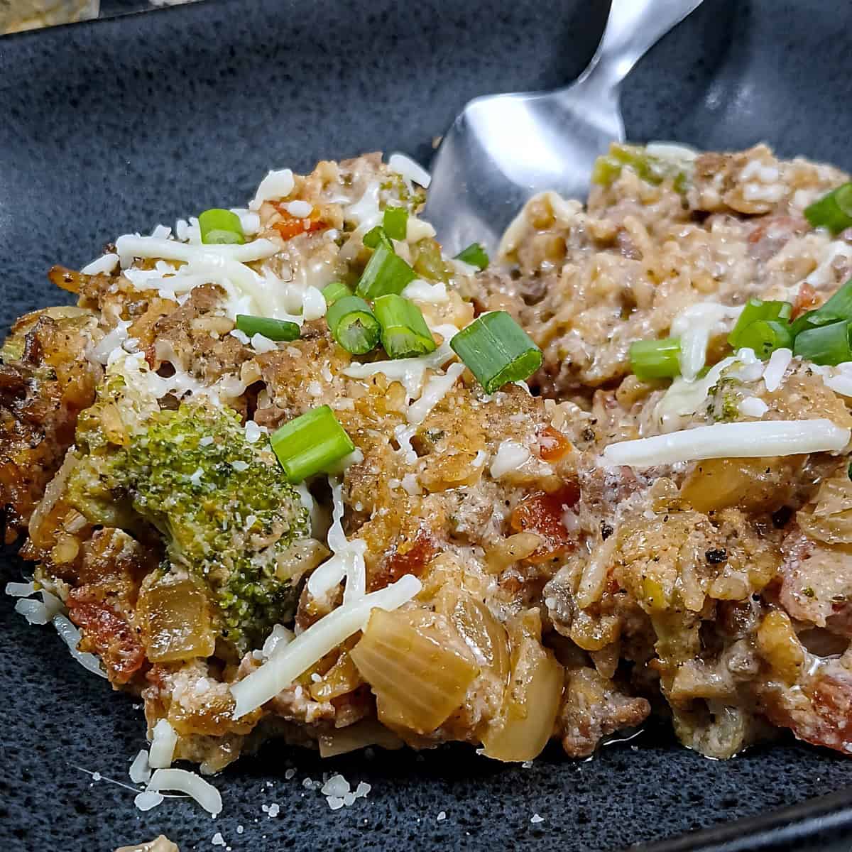 Low sodium Ground Beef & Rice Casserole closeup of serving in black dish.