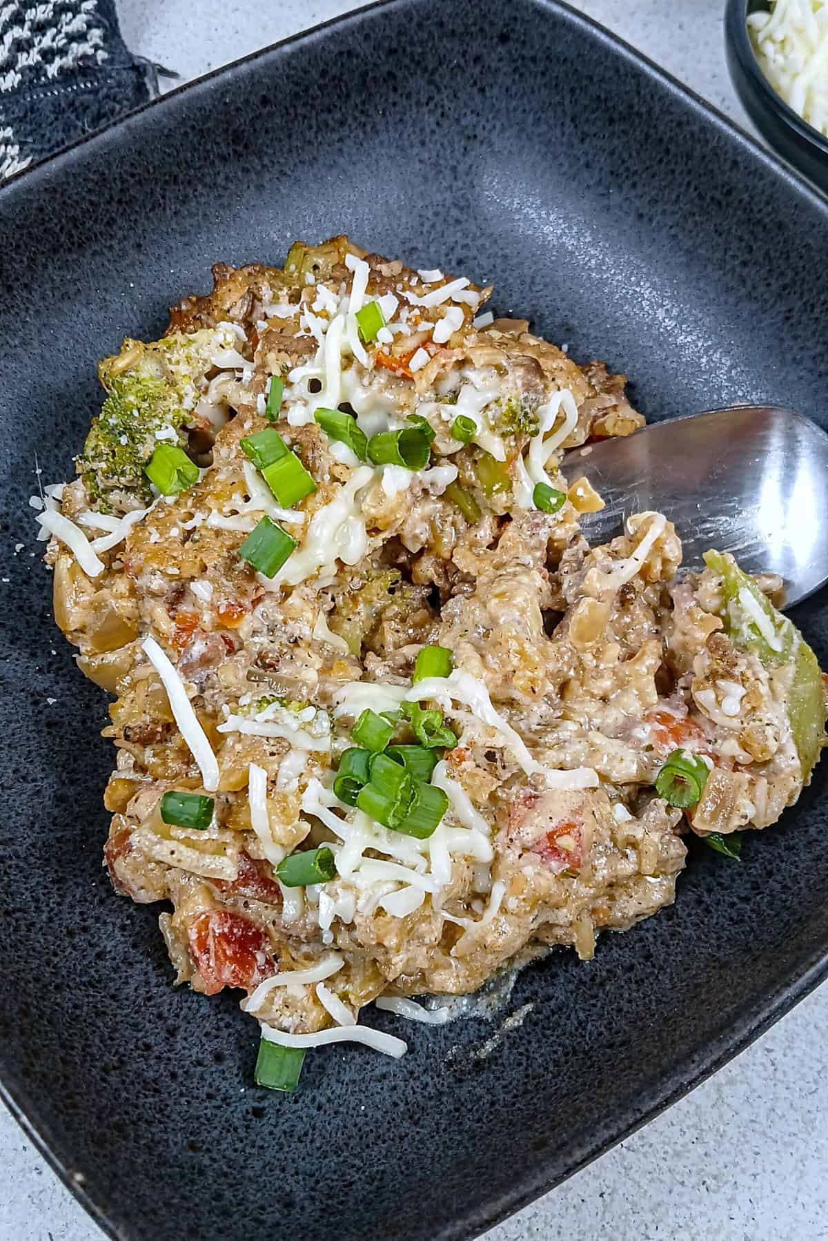 low sodium Ground Beef & Rice Casserole overhead view of plated dish in black stoneware bowl.