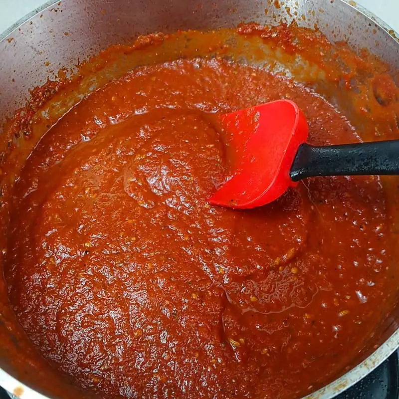 Process-shot-6 Completed sauce being stirred in pot with spatula.